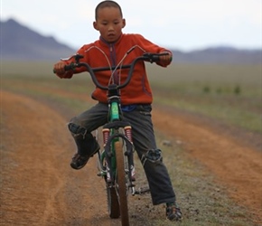 Child biker in the Gobi Desert