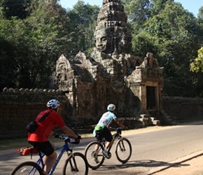 Steve and Chai pass gatehouse at Angkor complex