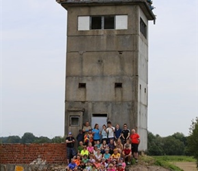 Group at corner East German watchtower
