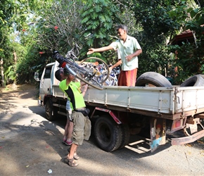 Thomas helps load the bikes for their trip back to Negombo