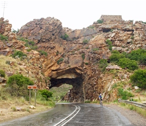 Steve Mayka through arch on the Kogmanskloof Pass. On top to the right is an Old English Fort