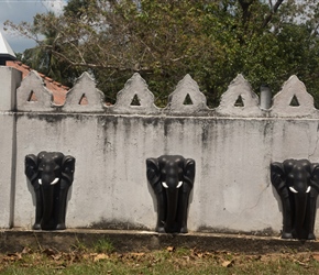 Many temples are decorated on the outside walls with black elephants with white tusks
