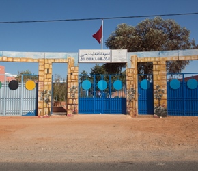 This was on the right, the entrance to a school in Mumurack with the Moroccan flag fluttering in the breeze
