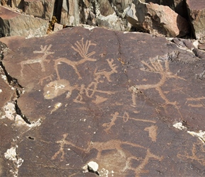 Petroglyths, deer and hunters with bows and arrows