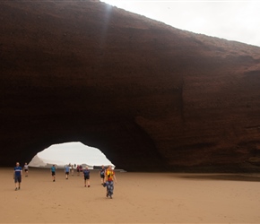 Walking through the arch at Plage Lgzira. In the UK there would be health and safety signs. The rock is soft and the boulders large. Hopefully the camels taking tourists too and frow are safe enough from skyward debris