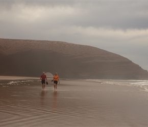 Peter and Claire walk the surf at Plage Lgzira