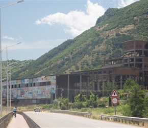 Sharon passes an old factory next to Lake Ohrid