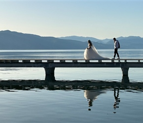 Bride and groom enjoy the deck on the lake